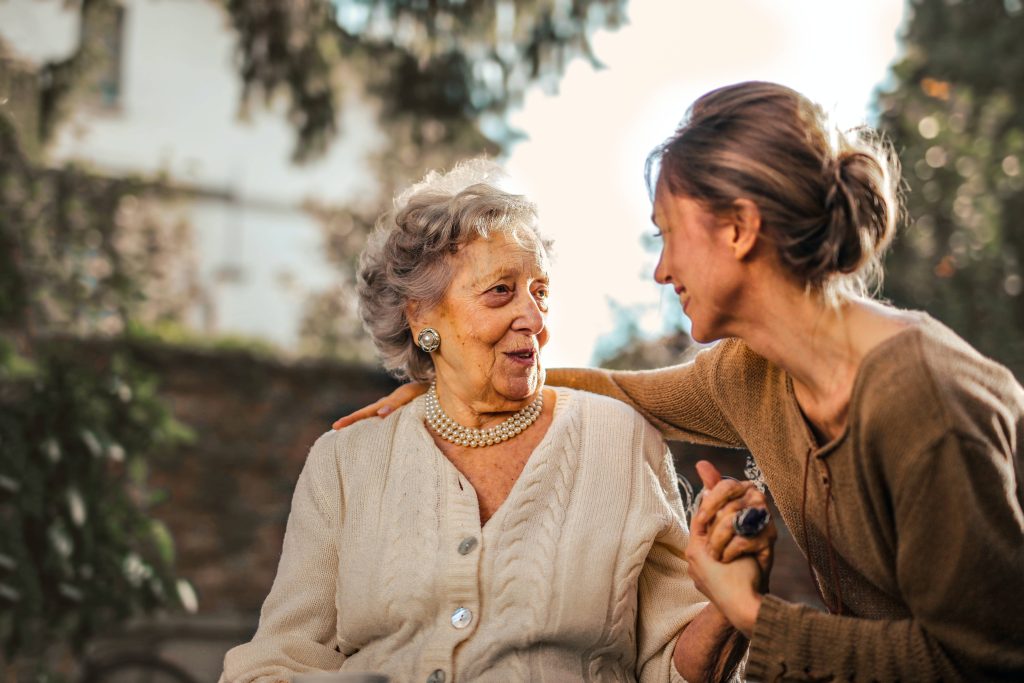 A_young_lady_talking_to_an_elderly_woman